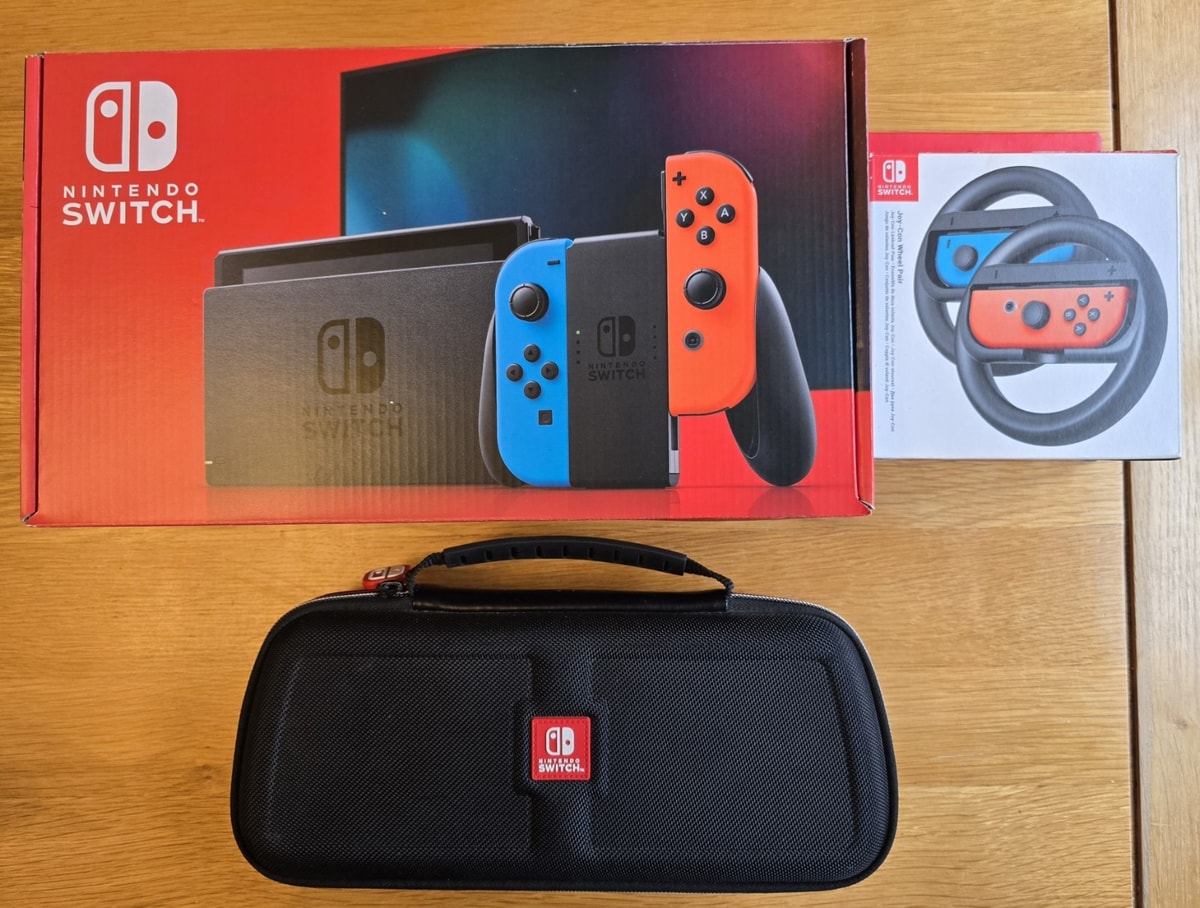 Nintendo Switch console Boxed + official Nintendo case & joycon wheels. see pics