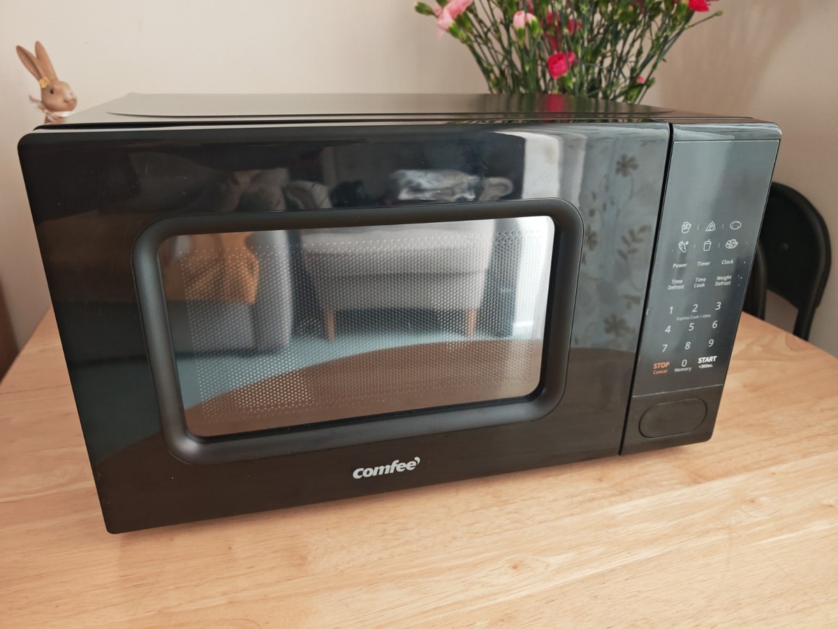 Comfee 700W Microwave Oven Black- New In Box But Hit a bit In The Back Side